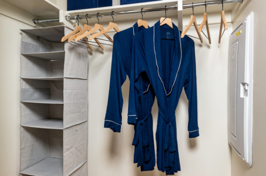 guest closet with robes hanging